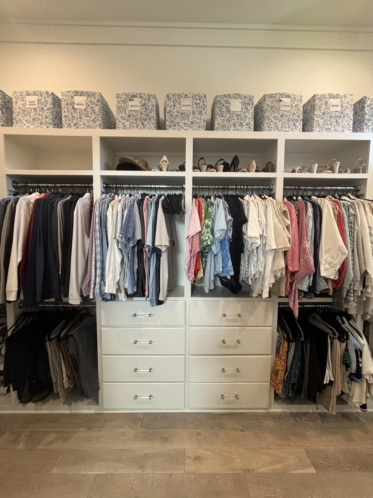 A Coastal Calm closet project with clothes organized in a walk-in wardrobe